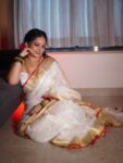 Mesmerizing White Plain Linen Saree with Golden Red Border Onam Special