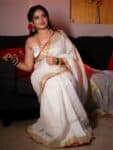 Mesmerizing White Plain Linen Saree with Golden Red Border Onam Special